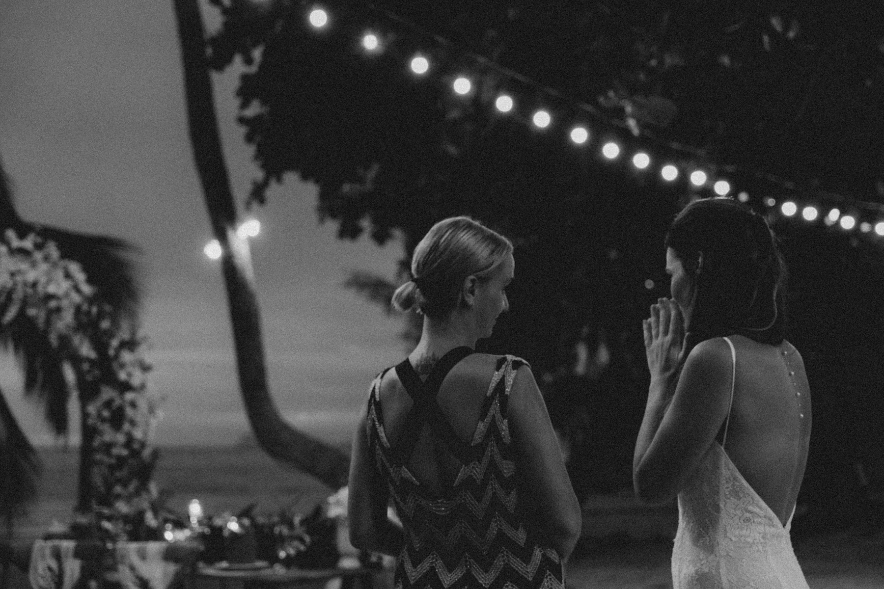 Katerina Gordeeva speaking with a bride during an evening celebration