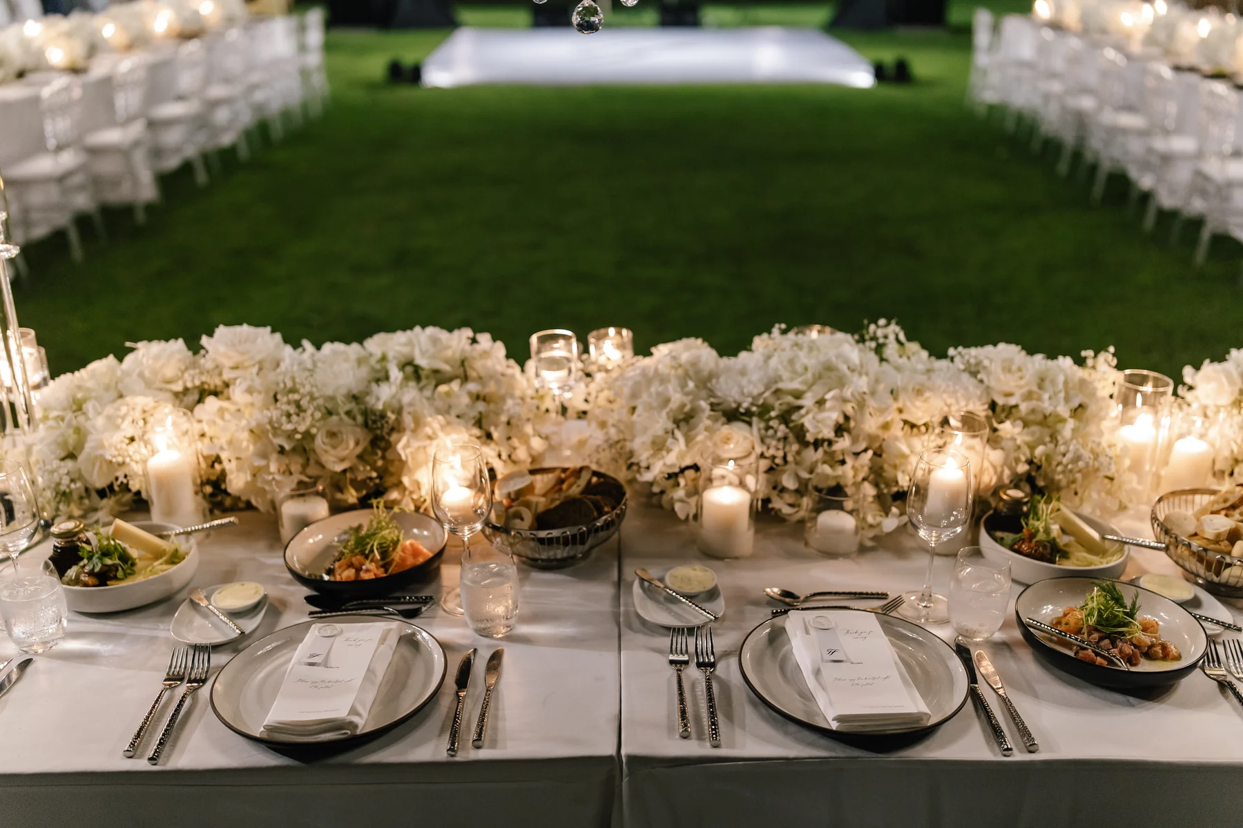 An elegant candlelit wedding table arranged for an evening celebration