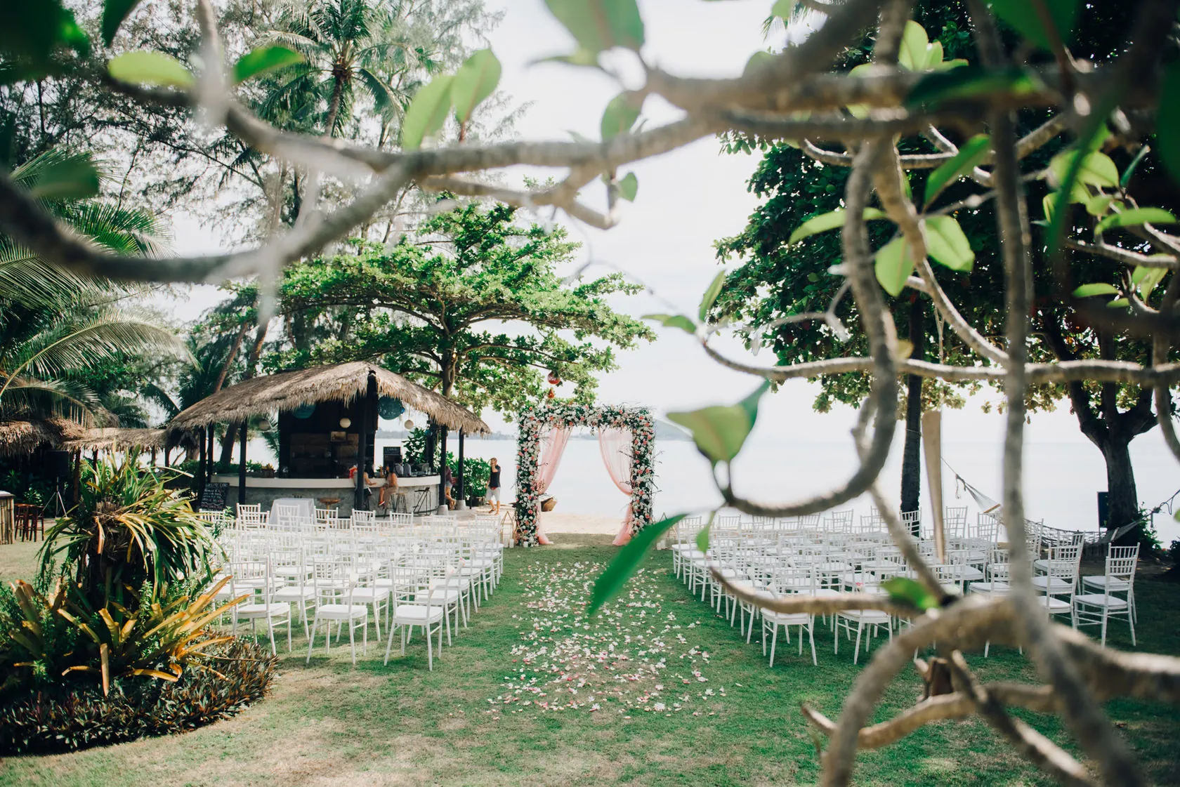 An ivory floral ceremony overlooking tropical hills