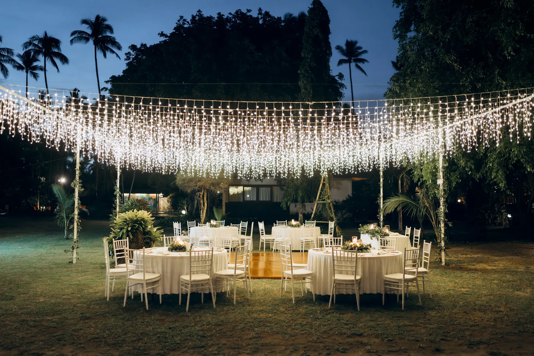 An ivory floral ceremony overlooking tropical hills