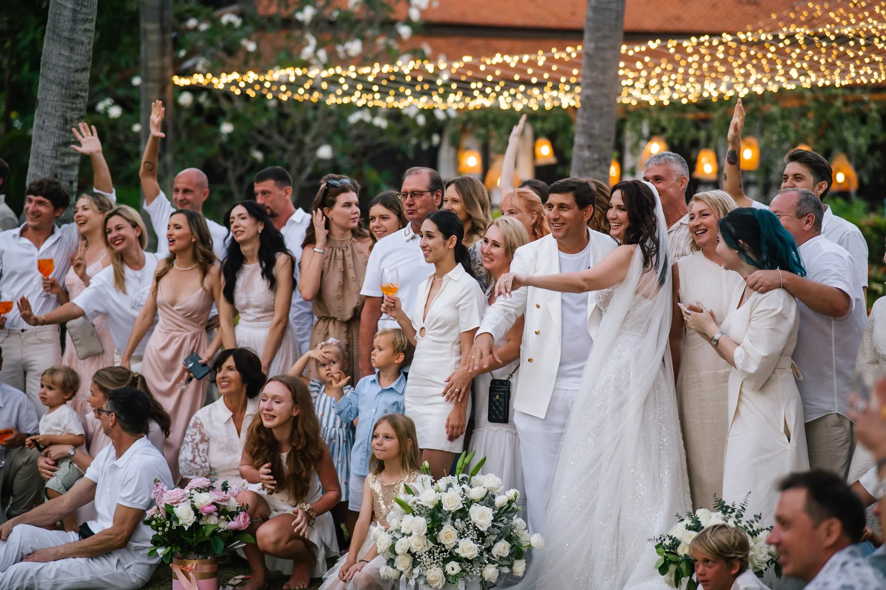 Guests celebrating together beneath tropical palms