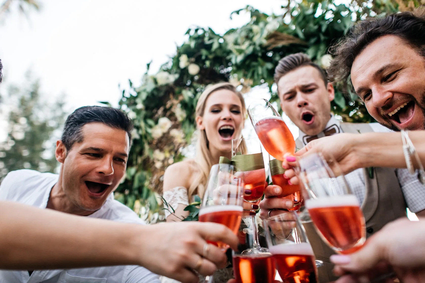 Guests celebrating with rosé during a wedding weekend event