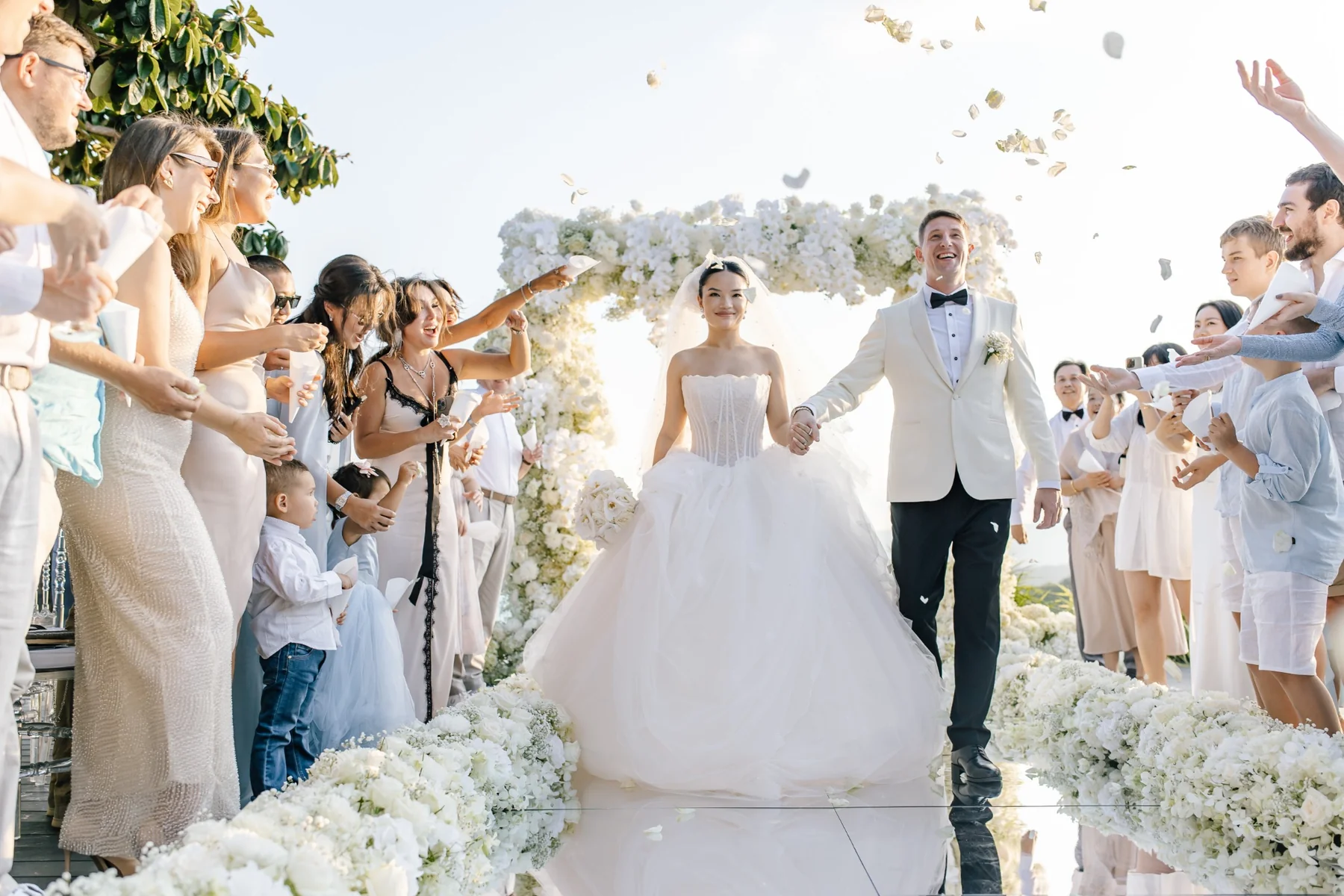 Newlyweds walking through their guests after the ceremony